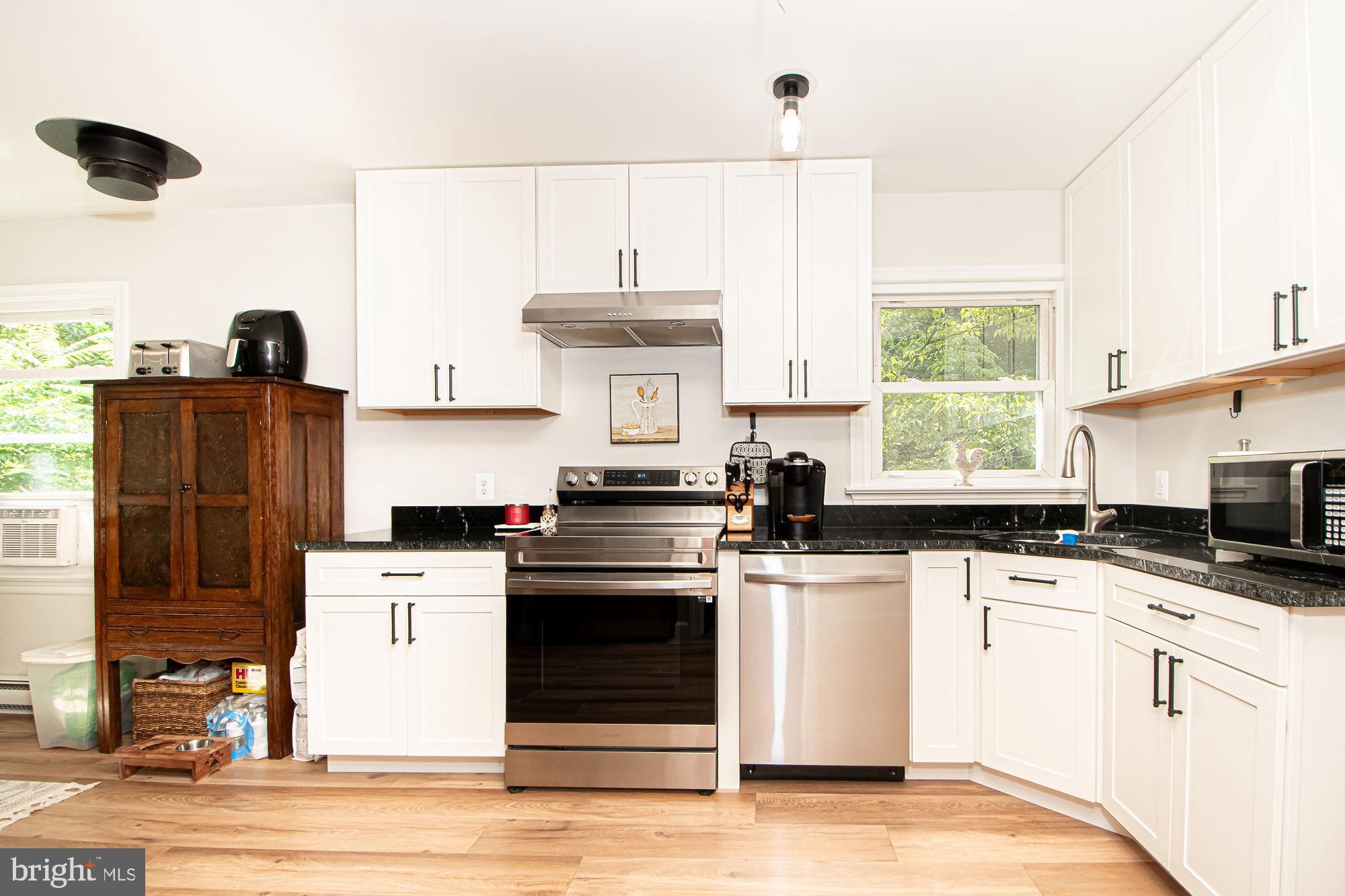 61 Mt Marshall Road Washington, VA 22747 - Photo 7 of 54 a kitchen with granite countertop a stove a sink and a refrigerator