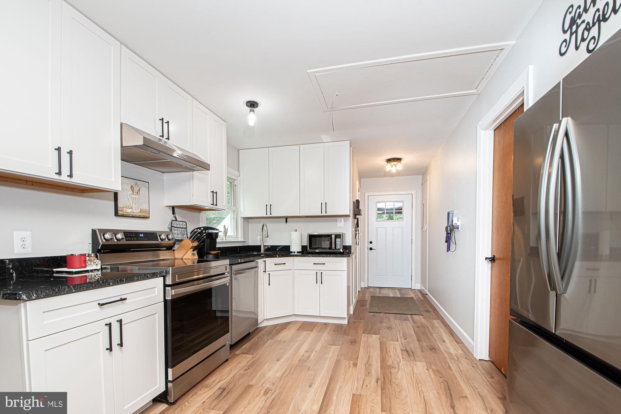 61 Mt Marshall Road Washington, VA 22747 - Photo 8 of 54 a kitchen with granite countertop a refrigerator stove top oven and sink