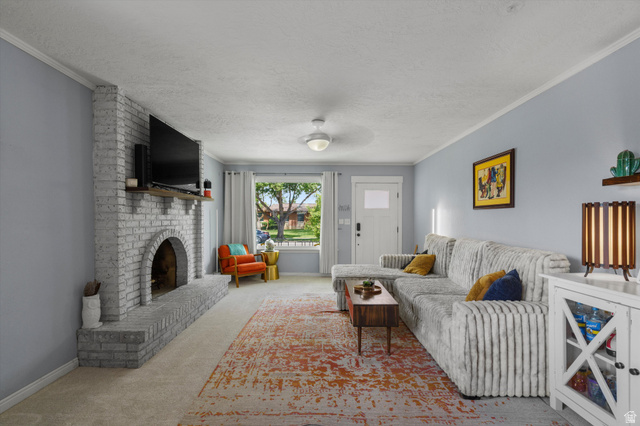 961 33rd Street Ogden, UT 84403 - Photo 6 of 39 Living room featuring a painted brick fireplace with a wood mantle, neutral carpeting, and light blue wall tones