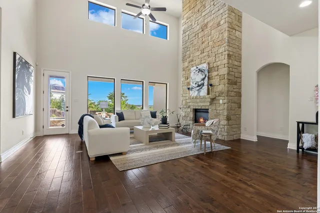 a living room with fireplace furniture wooden floor and a fireplace
