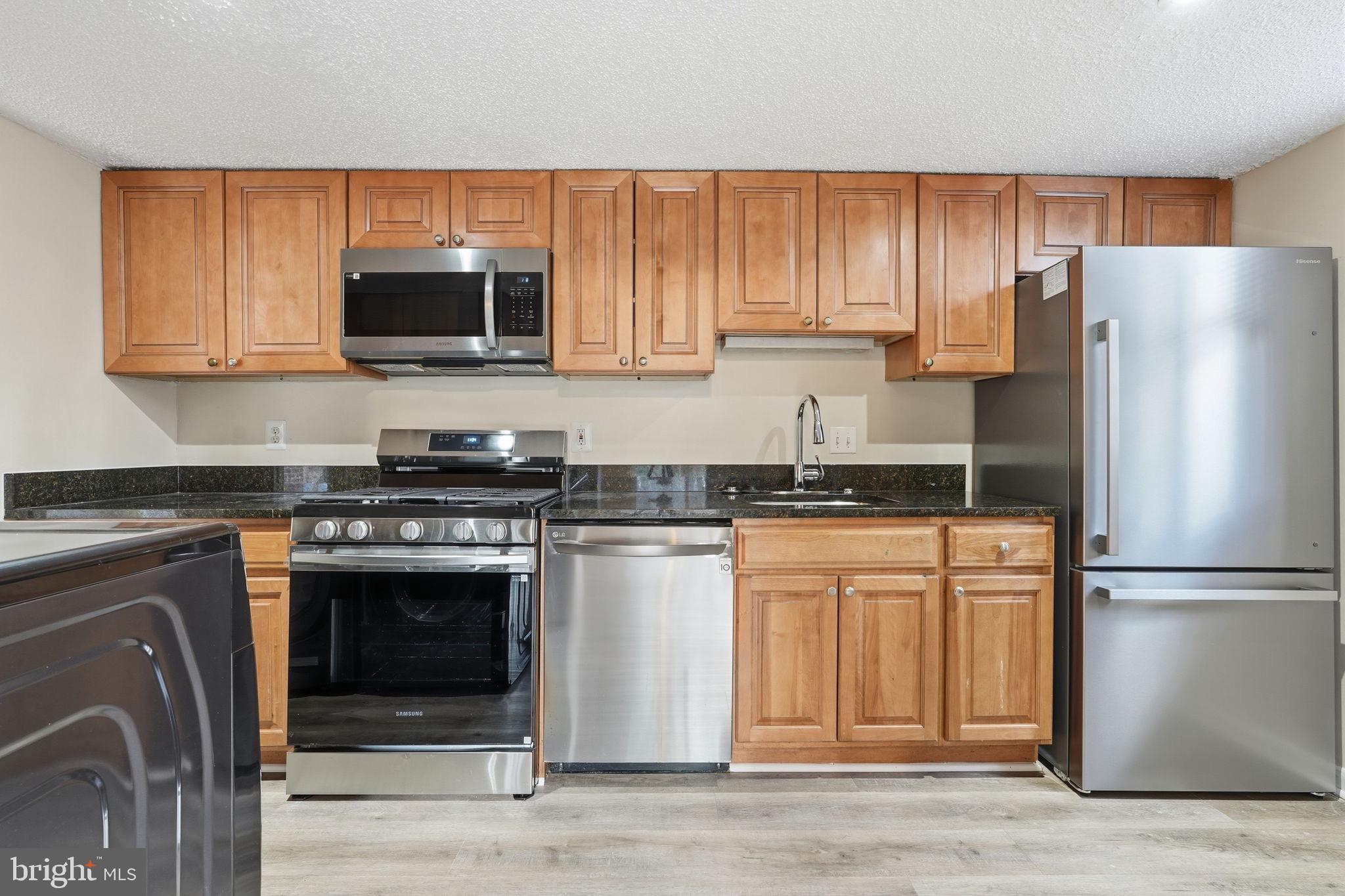 11807 Breton Court, Unit 2B Reston, VA 20191 - Photo 11 of 30 Sleek granite countertops.