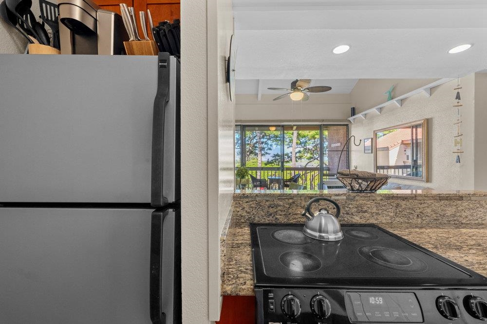 2191 South Kihei Road, Unit 2413 Kihei, HI 96753 - Photo 14 of 32 a kitchen with a sink and a refrigerator