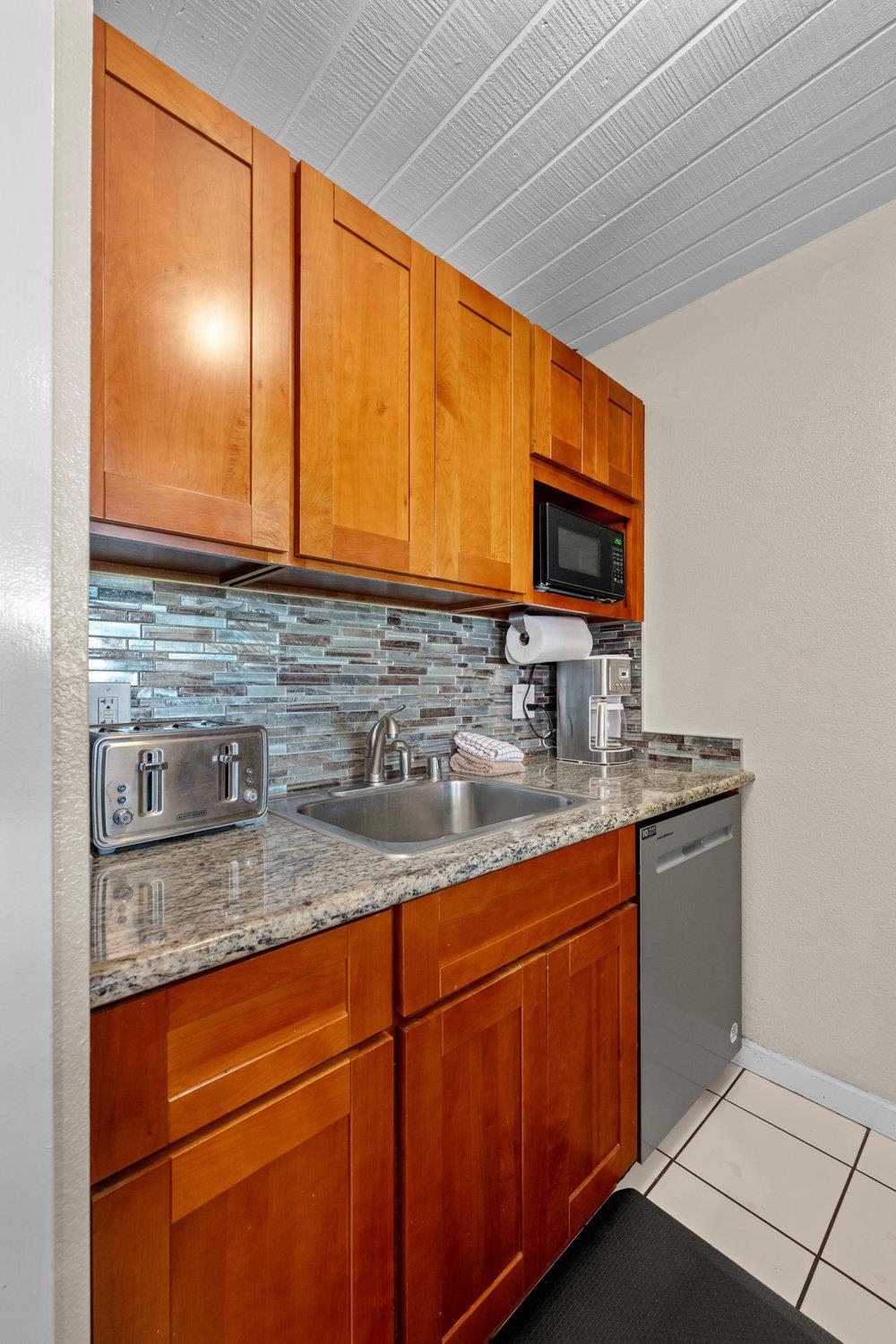 2191 South Kihei Road, Unit 2413 Kihei, HI 96753 - Photo 16 of 32 a kitchen with stainless steel appliances granite countertop a sink stove and cabinets