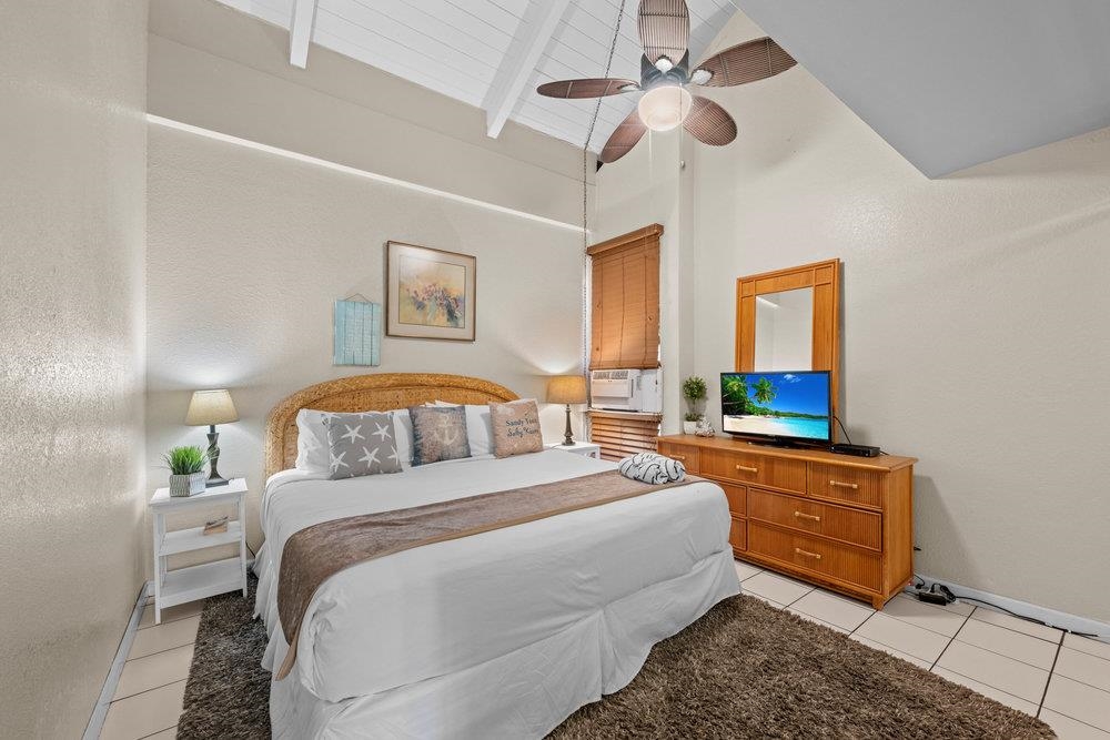2191 South Kihei Road, Unit 2413 Kihei, HI 96753 - Photo 17 of 32 a bedroom with a bed and a mirror on dresser