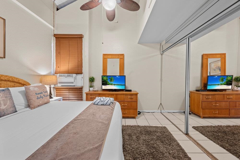 2191 South Kihei Road, Unit 2413 Kihei, HI 96753 - Photo 18 of 32 a bedroom with furniture and a fireplace