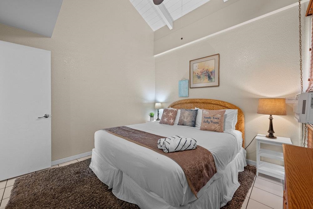 2191 South Kihei Road, Unit 2413 Kihei, HI 96753 - Photo 19 of 32 a bedroom with a bed and a lamp