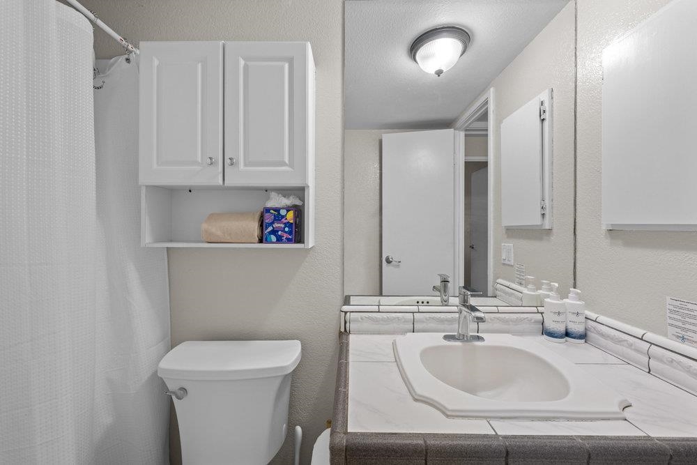 2191 South Kihei Road, Unit 2413 Kihei, HI 96753 - Photo 22 of 32 a bathroom with a sink a toilet and a mirror