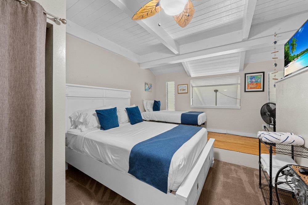 2191 South Kihei Road, Unit 2413 Kihei, HI 96753 - Photo 23 of 32 a bedroom with a bed and a chandelier