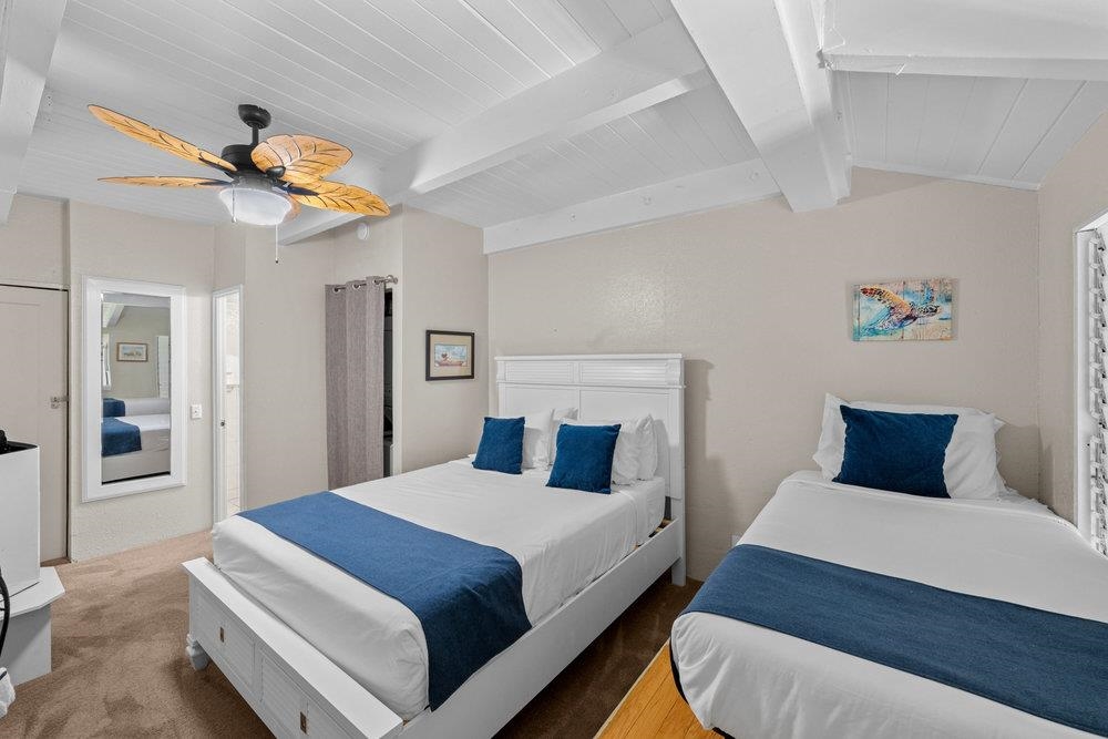 2191 South Kihei Road, Unit 2413 Kihei, HI 96753 - Photo 25 of 32 a bedroom with a bed and a chandelier