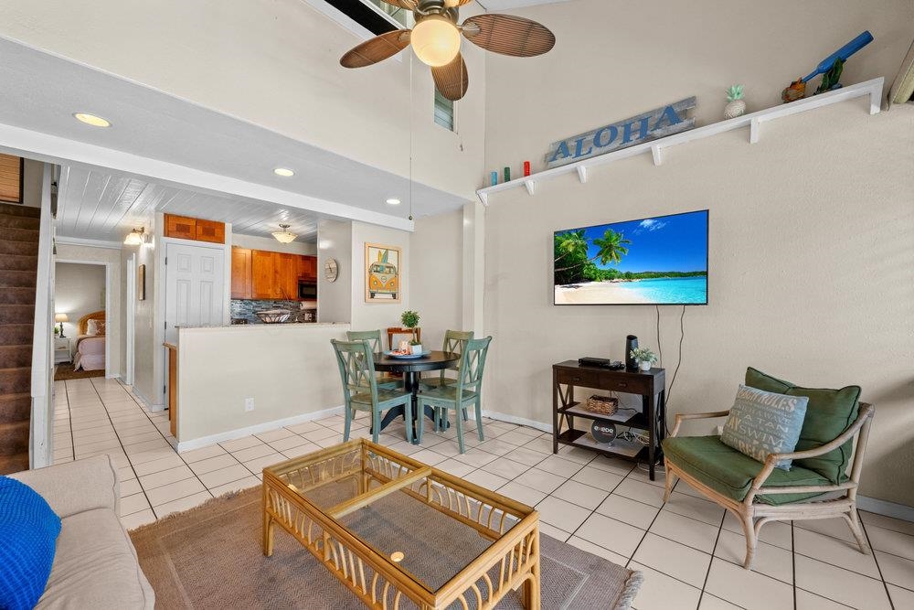 2191 South Kihei Road, Unit 2413 Kihei, HI 96753 - Photo 5 of 32 a living room with furniture a flat screen tv and kitchen view
