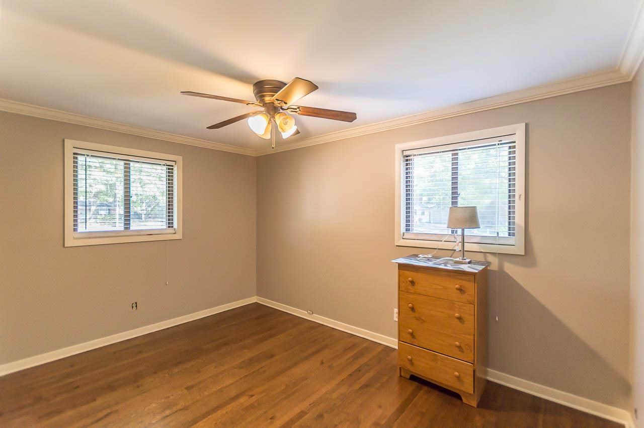 5093 Dee Road Memphis, TN 38117 - Photo 14 of 21 a view of an empty room with a window and wooden floor