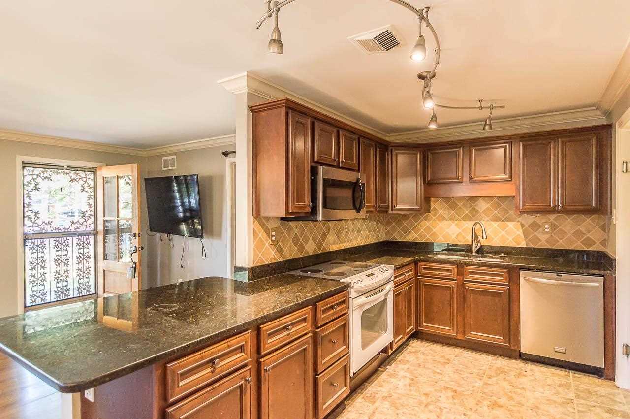 5093 Dee Road Memphis, TN 38117 - Photo 9 of 21 a kitchen with stainless steel appliances granite countertop a sink window and cabinets