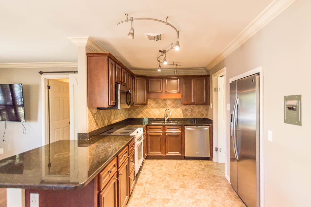 5093 Dee Road Memphis, TN 38117 - Photo 10 of 21 a kitchen with stainless steel appliances granite countertop a sink a stove and a refrigerator