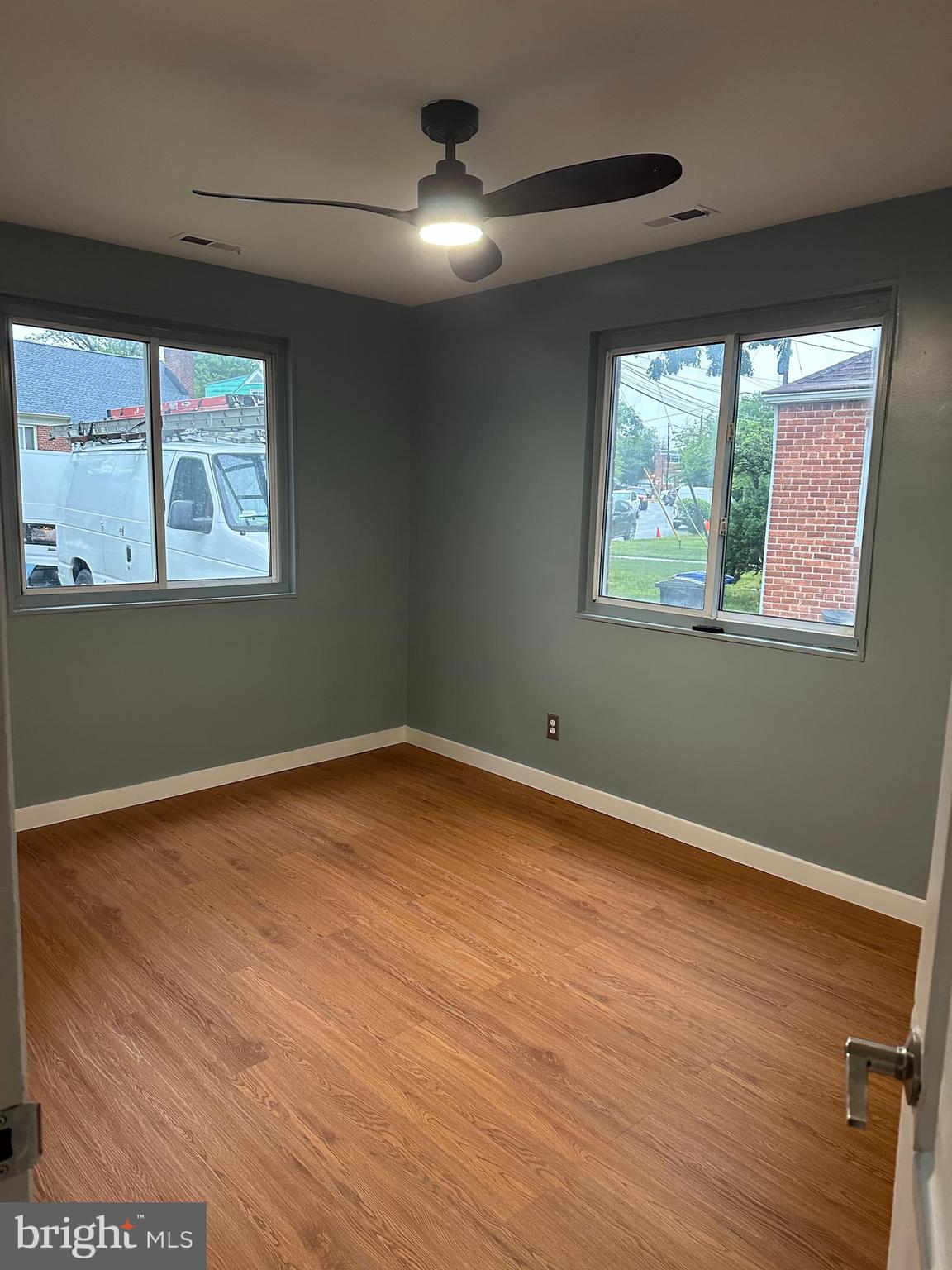 8411 11th Avenue Silver Spring, MD 20903 - Photo 11 of 24 an empty room with wooden floor and windows