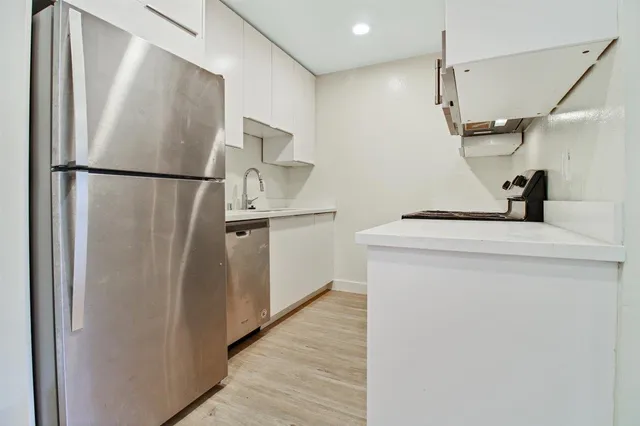 a kitchen with stainless steel appliances a refrigerator and a sink