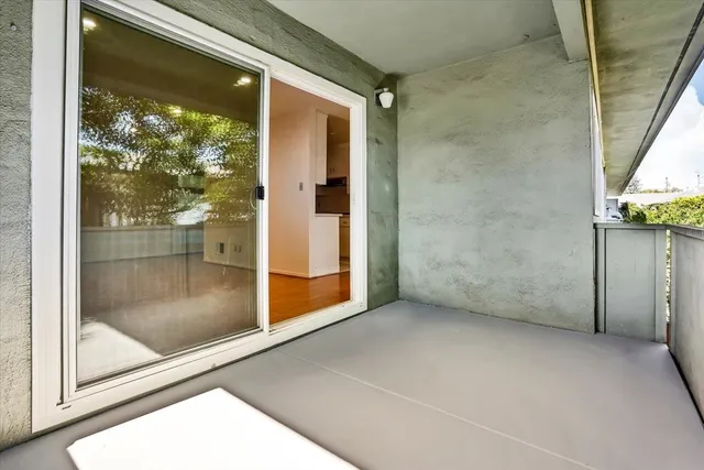 a view of a glass door with wooden floor
