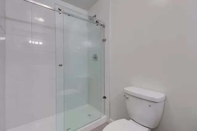 a bathroom with a shower a toilet and a shower