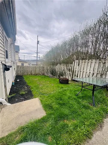 a living room with furniture and floor to ceiling windows