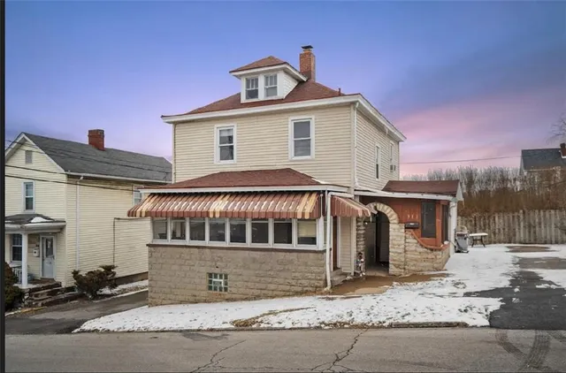 a view of a house with a snow in the background