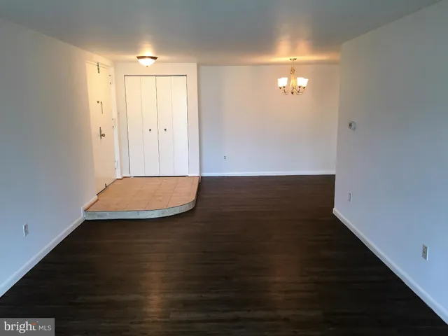 an empty room with wooden floor