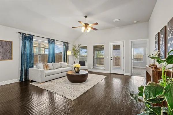 a living room with furniture and a potted plant