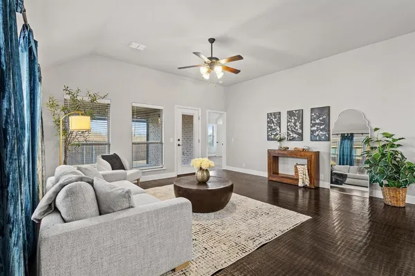 a living room with furniture and a dining table