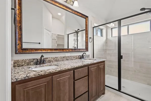 a bathroom with a granite countertop sink and a mirror