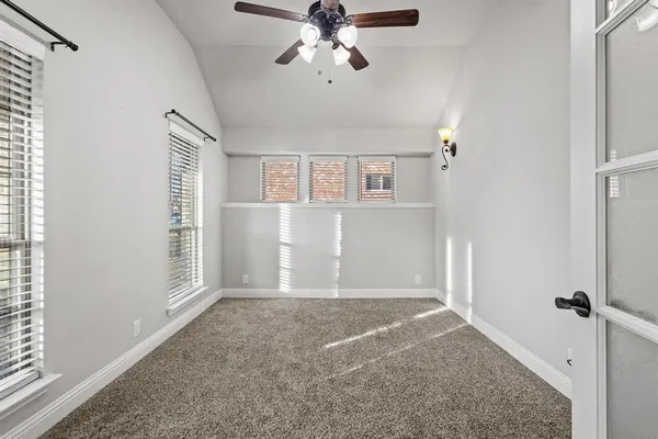 a view of a livingroom with a ceiling fan and window