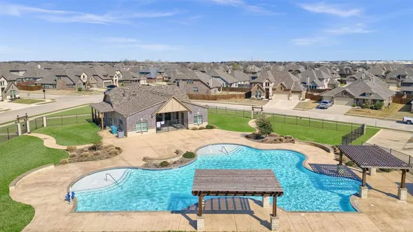 an aerial view of a house with yard swimming pool and outdoor seating