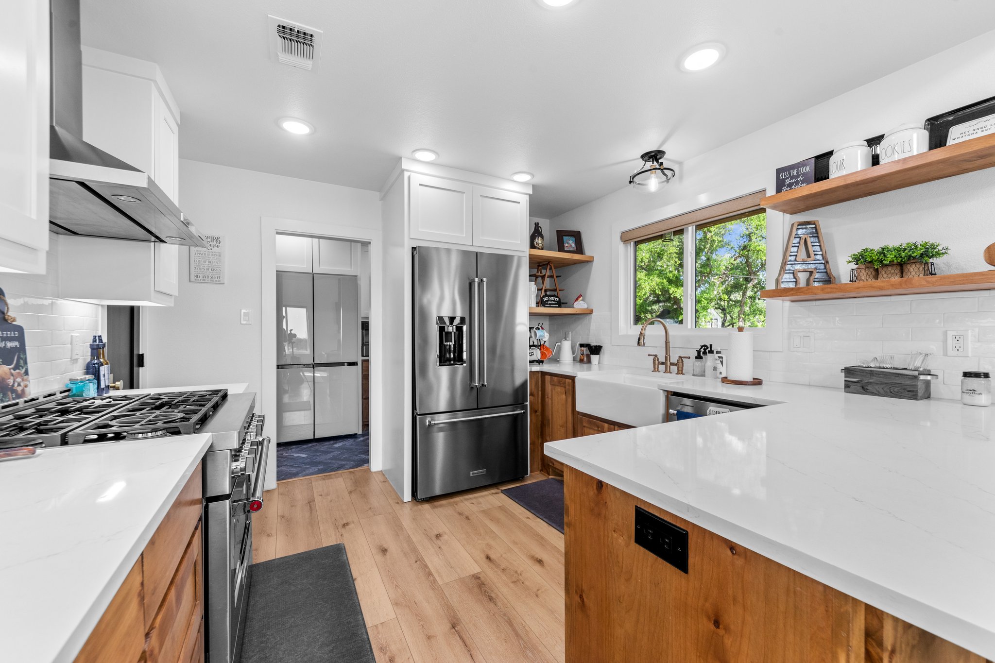 1800 Diamond Ridge Drive Lampasas, TX 76550 - Photo 12 of 40 Kitchen featuring tasteful backsplash, premium appliances, light wood-style floors, light stone counters, and recessed lighting