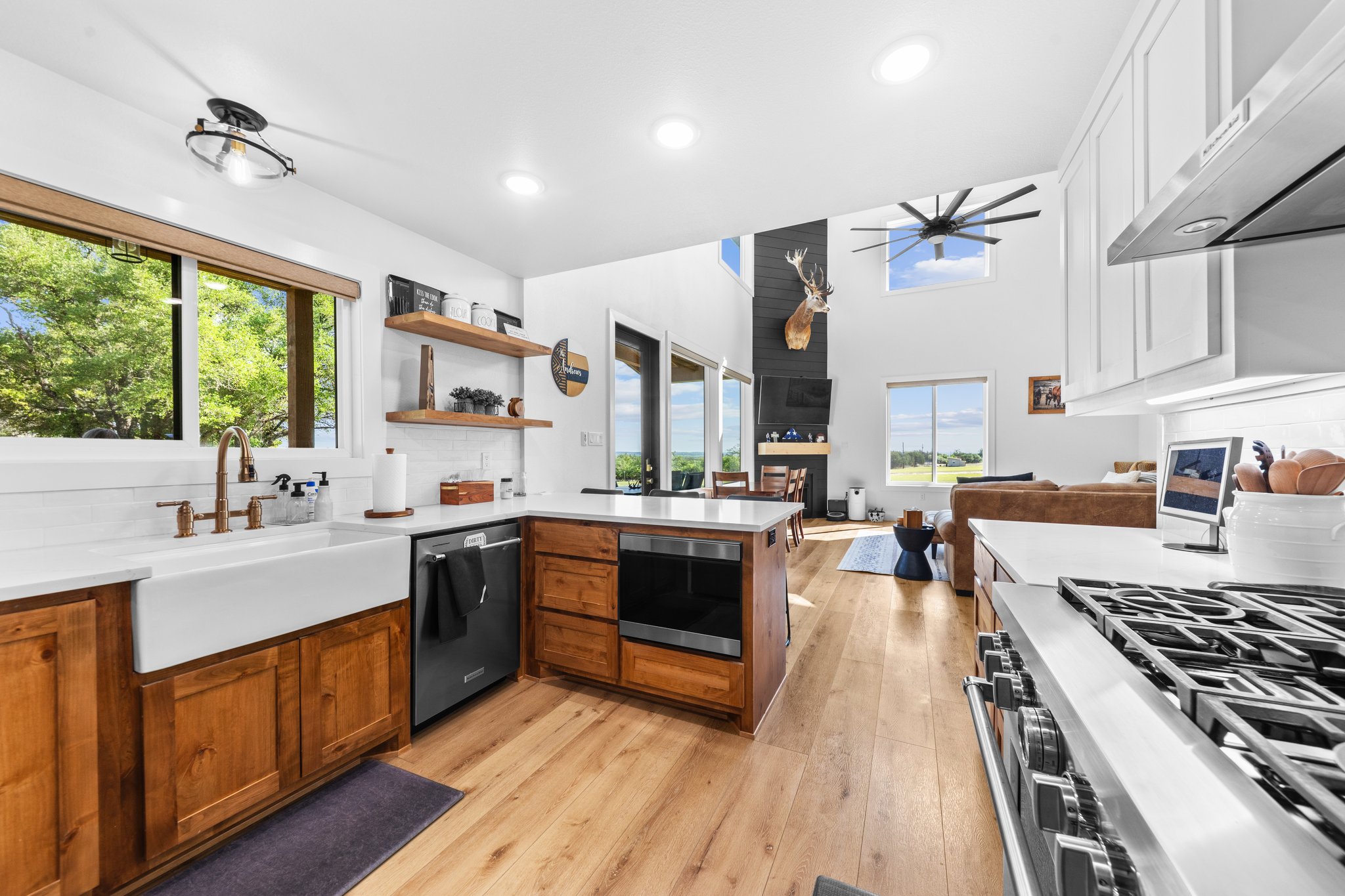 1800 Diamond Ridge Drive Lampasas, TX 76550 - Photo 40 of 40 Kitchen featuring a fireplace, a peninsula, open floor plan, light wood finished floors, and a ceiling fan