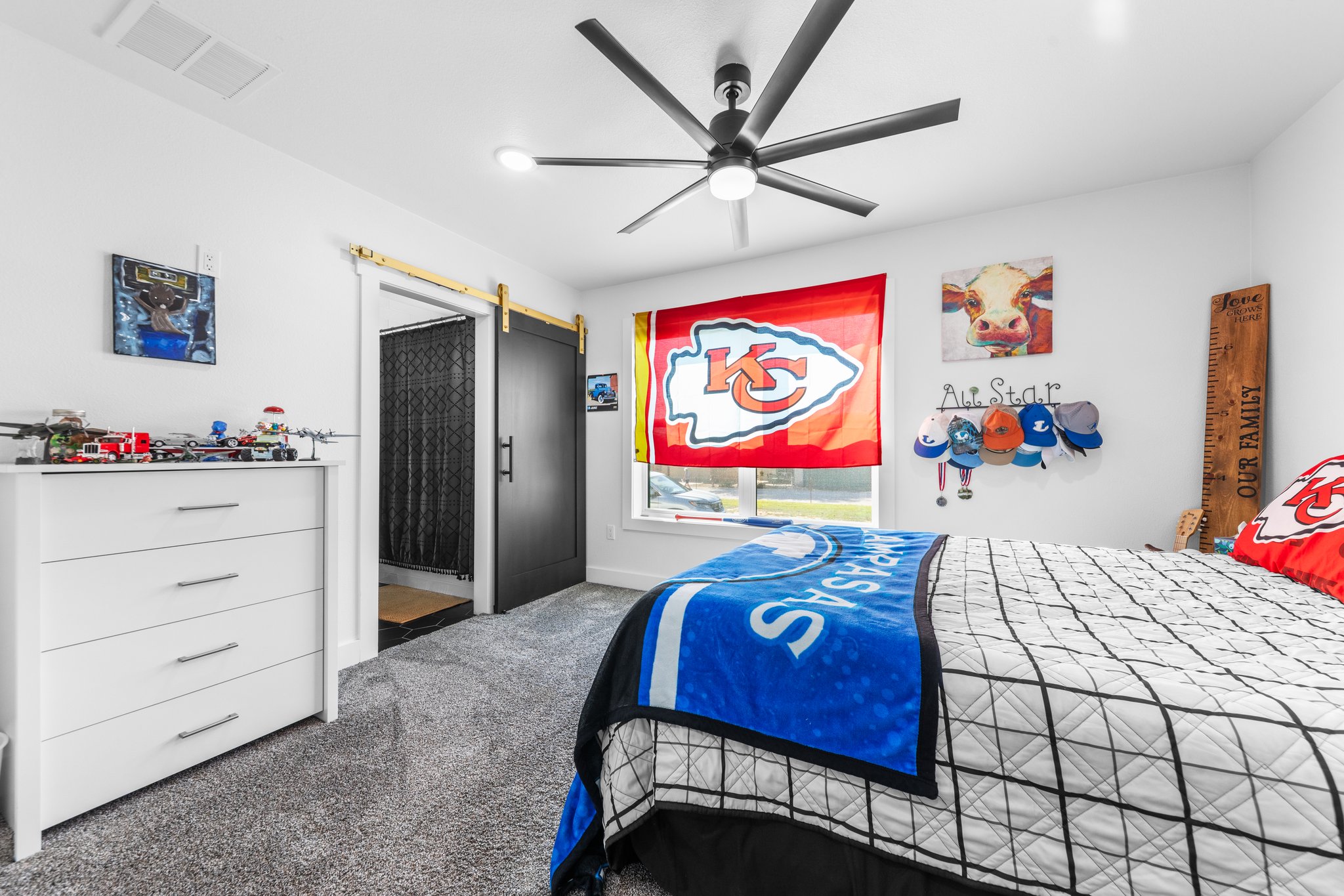 1800 Diamond Ridge Drive Lampasas, TX 76550 - Photo 25 of 40 Bedroom featuring a barn door, dark colored carpet, and ceiling fan