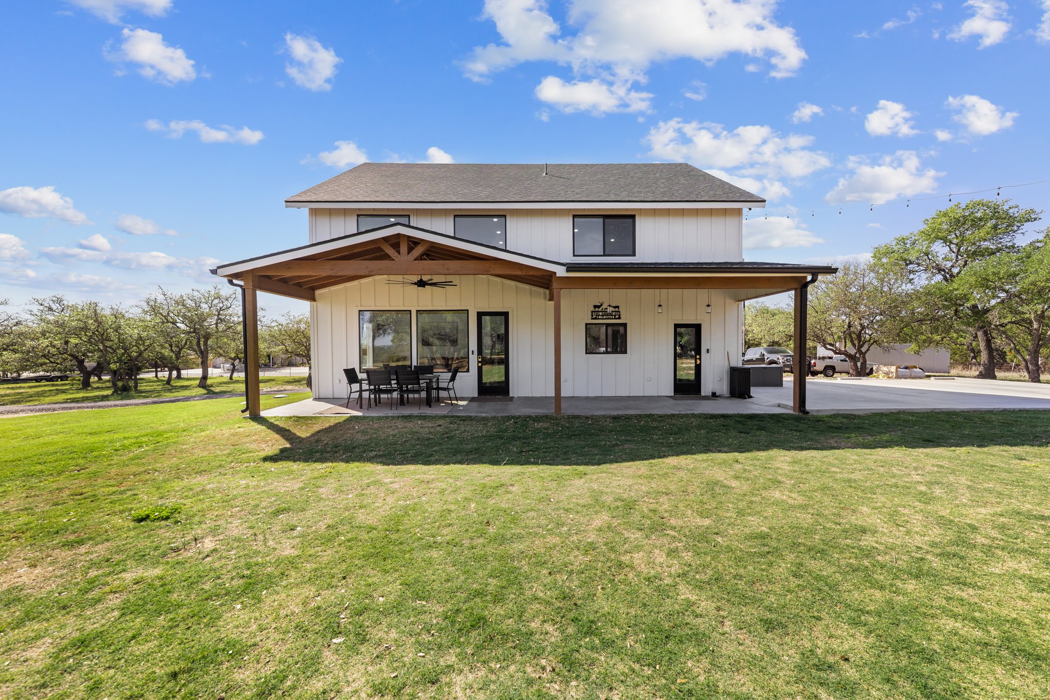 1800 Diamond Ridge Drive Lampasas, TX 76550 - Photo 30 of 40 Back of property featuring ceiling fan, a yard, a patio, and roof with shingles