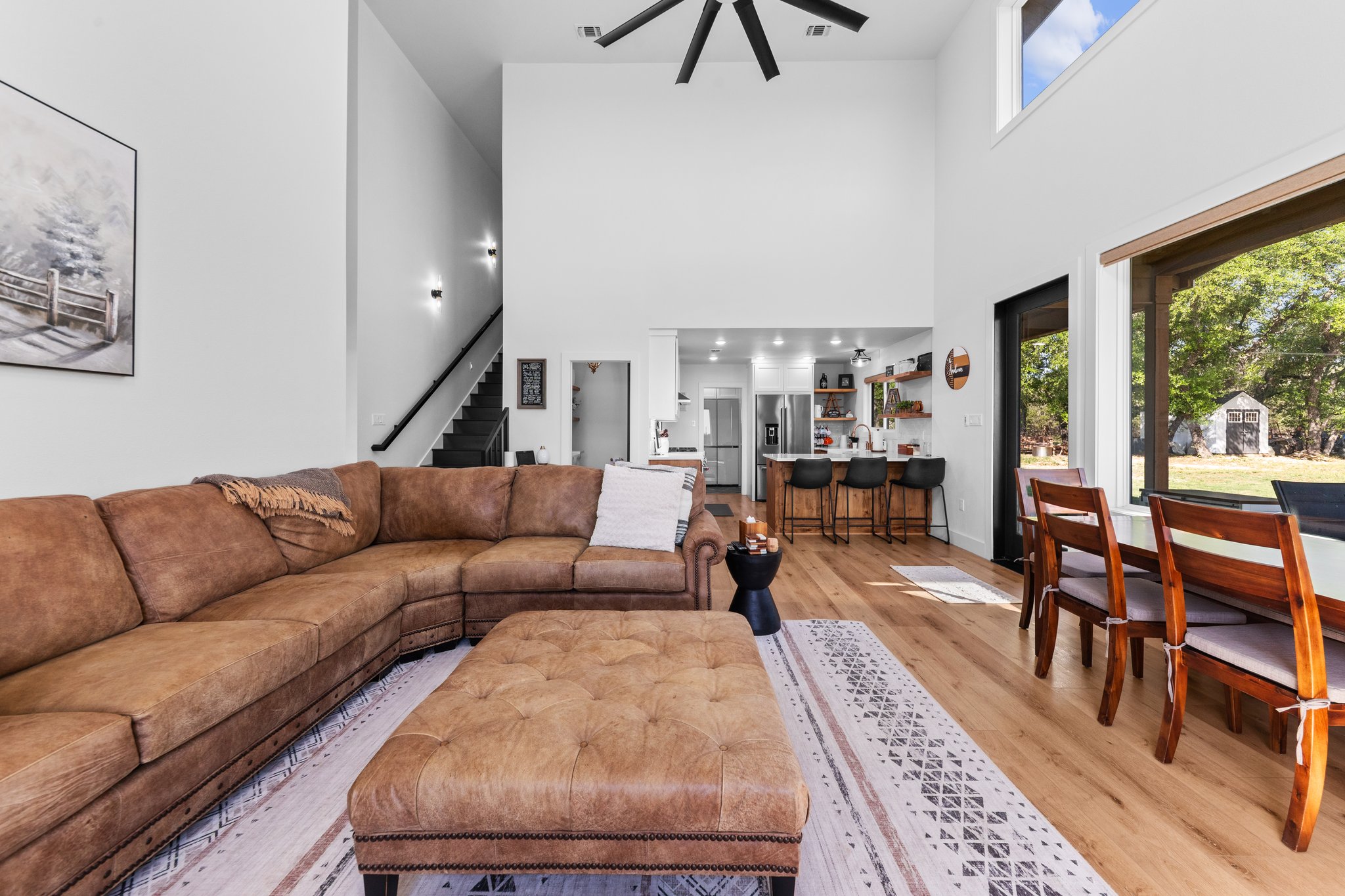 1800 Diamond Ridge Drive Lampasas, TX 76550 - Photo 8 of 40 Living room featuring plenty of natural light, light wood-type flooring, ceiling fan, and a high ceiling