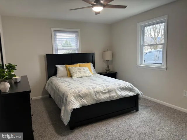 a bed sitting in a bedroom next to a window