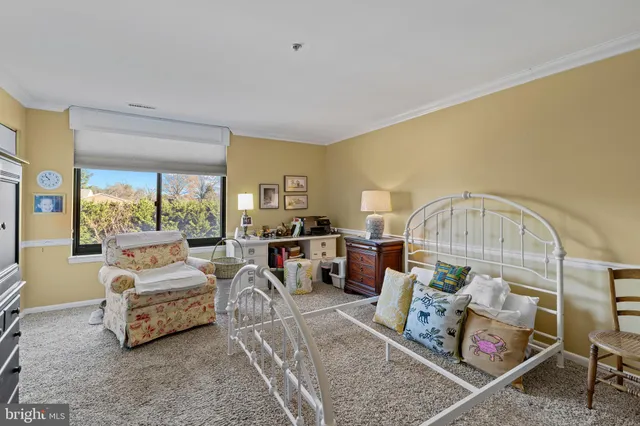 a bedroom with furniture and a large window