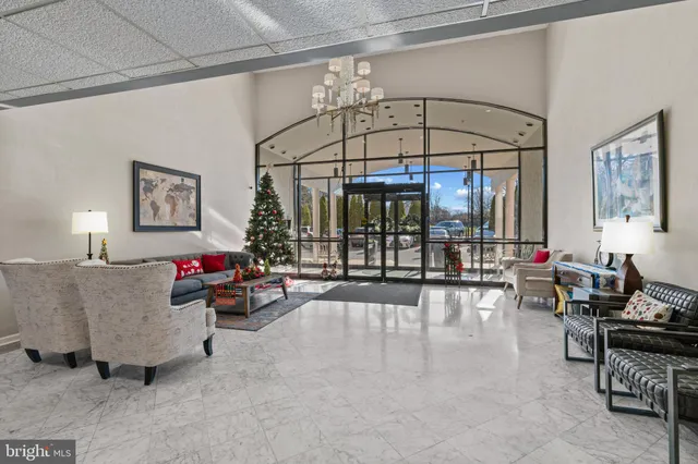 a living room with furniture and a chandelier