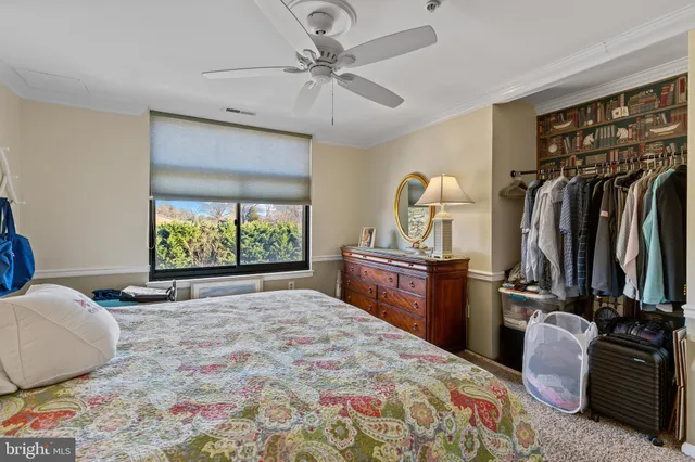 a bedroom with a bed and a television