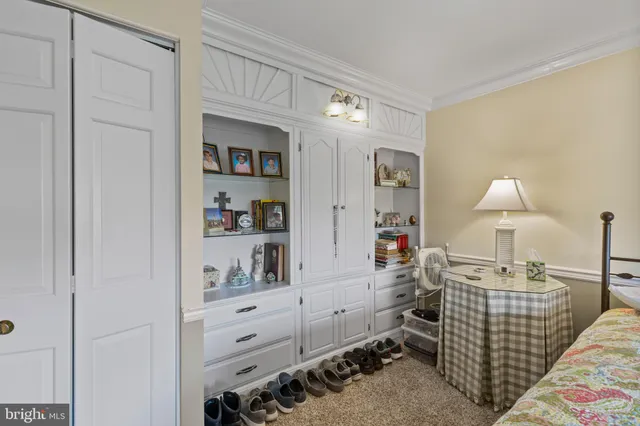 a bedroom with furniture and a lamp