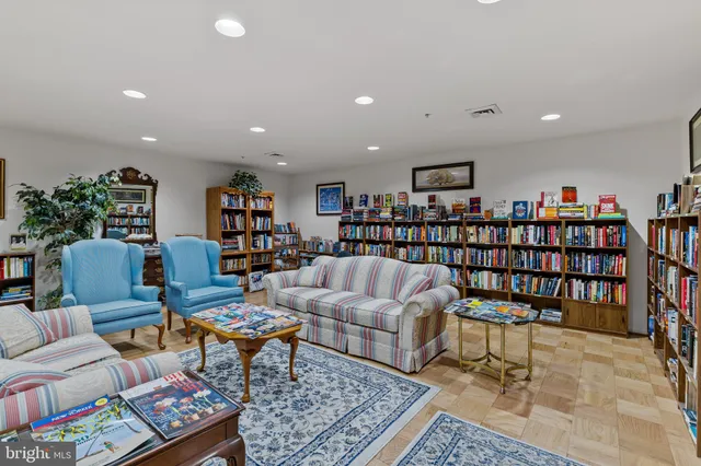 a living room with lots of furniture and a book shelf