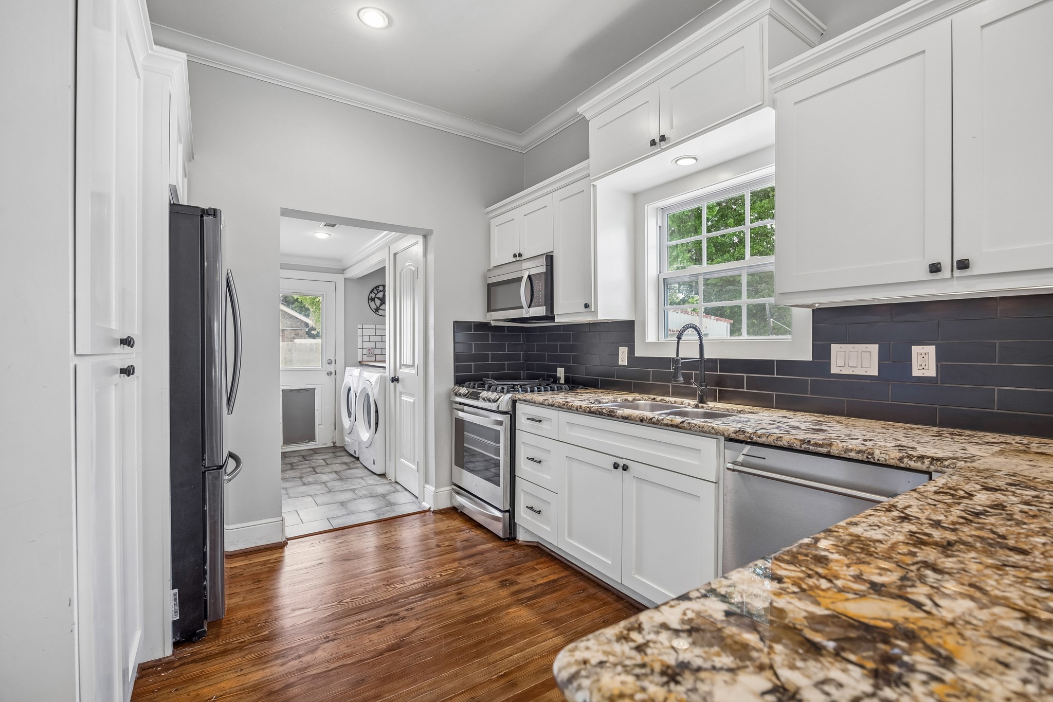 4412 Rusk Street Houston, TX 77023 - Photo 13 of 44 Note the high-end stainless appliances recently added by seller, along with gorgeous hardwood floors that continue throughout kitchen.