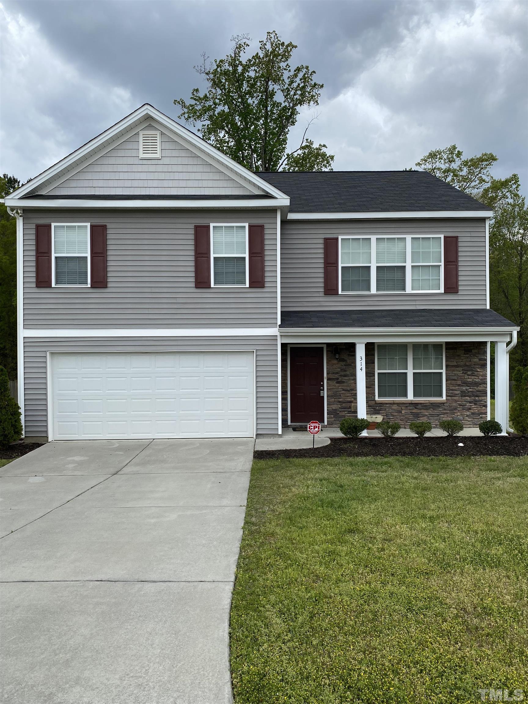 314 Botanical Court Bunnlevel, NC 28323 - Photo 1 of 8 a front view of a house with a garden