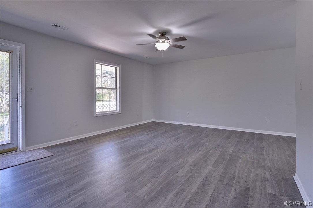 175 Racefield Drive Toano, VA 23168 - Photo 3 of 32 an empty room with wooden floor chandelier fan and windows