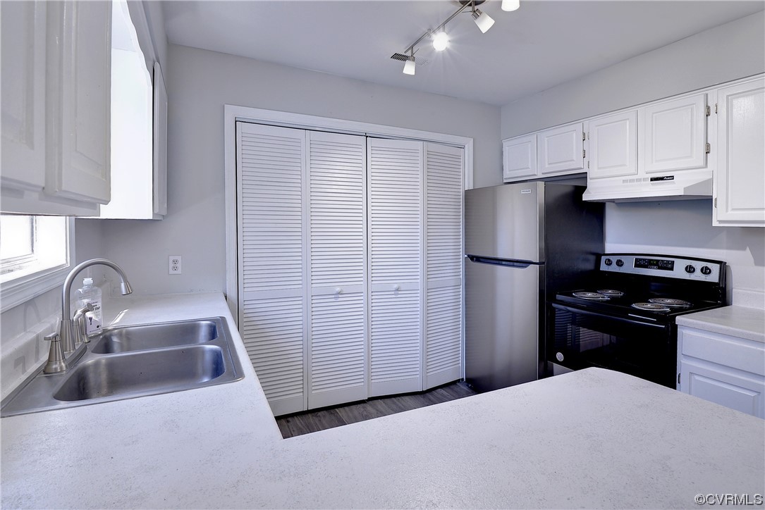 175 Racefield Drive Toano, VA 23168 - Photo 10 of 32 a kitchen with a refrigerator sink and white cabinets