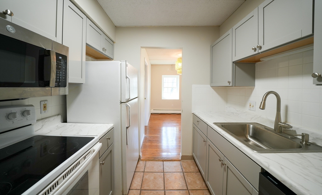 16 Winter Street, Unit 41A Waltham, MA 02451 - Photo 1 of 27 a kitchen with stainless steel appliances granite countertop a sink stove and refrigerator