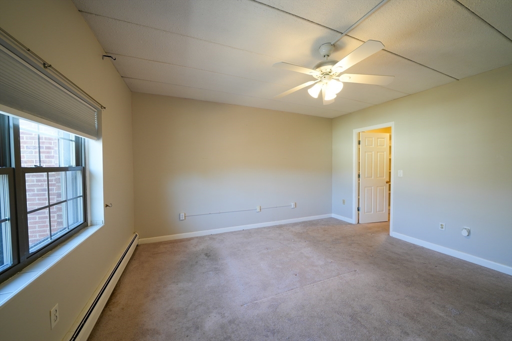16 Winter Street, Unit 41A Waltham, MA 02451 - Photo 11 of 27 an empty room with fan and windows