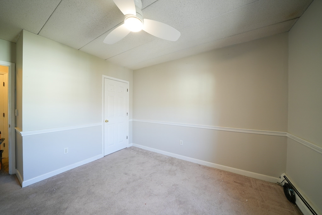 16 Winter Street, Unit 41A Waltham, MA 02451 - Photo 17 of 27 an empty room with a ceiling fan and window