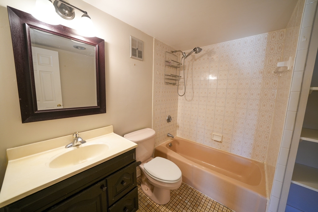16 Winter Street, Unit 41A Waltham, MA 02451 - Photo 18 of 27 a bathroom with a granite countertop sink toilet and shower