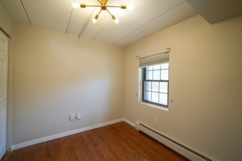 16 Winter Street, Unit 41A Waltham, MA 02451 - Photo 23 of 27 an empty room with a window and ceiling fan