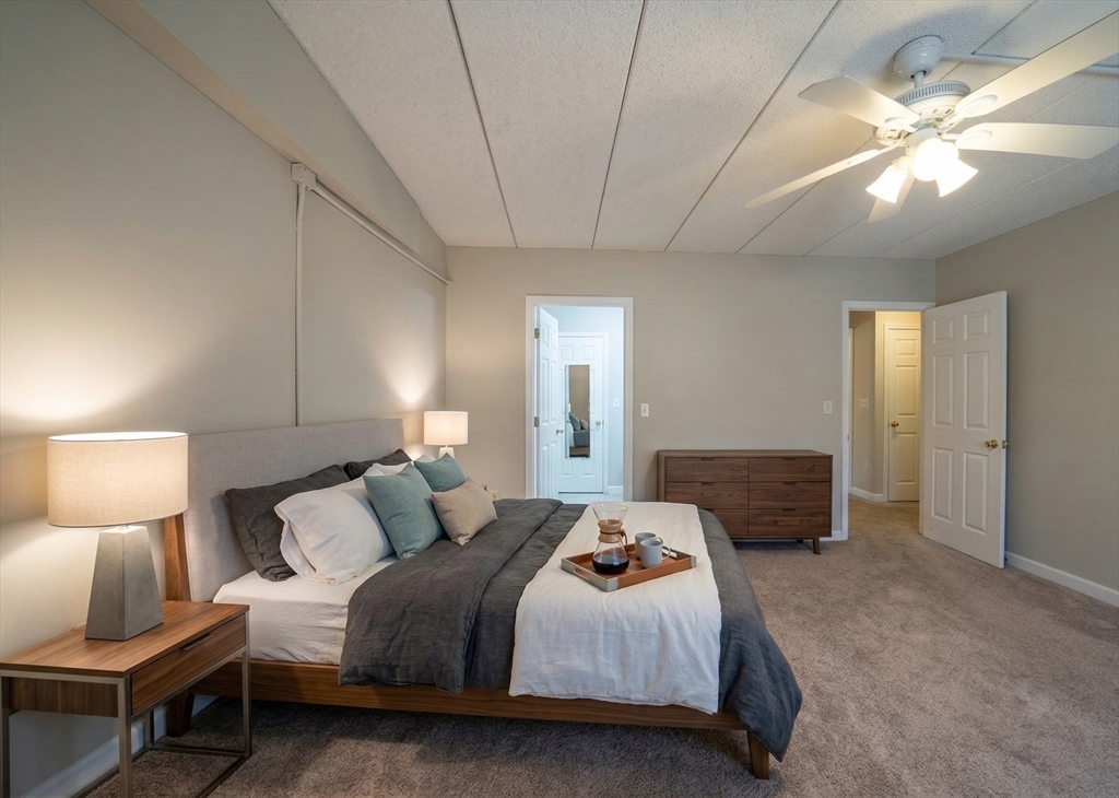 16 Winter Street, Unit 41A Waltham, MA 02451 - Photo 8 of 27 a bedroom with a bed and a lamp with window